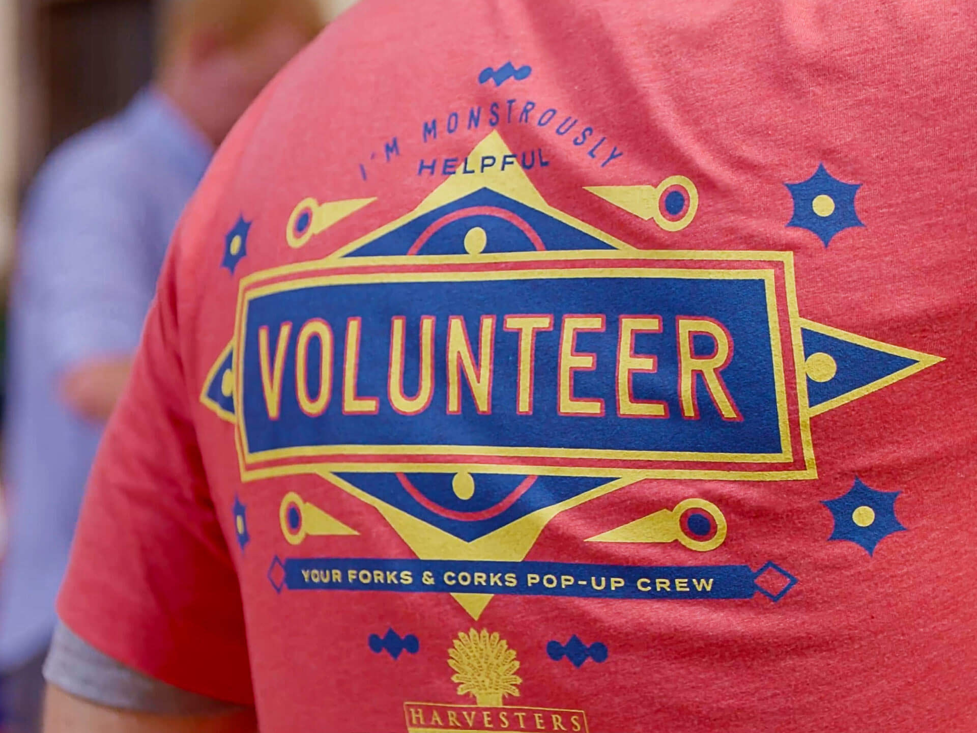 Closeup of ornate design saying "VOLUNTEER" printed on a volunteer's t-shirt