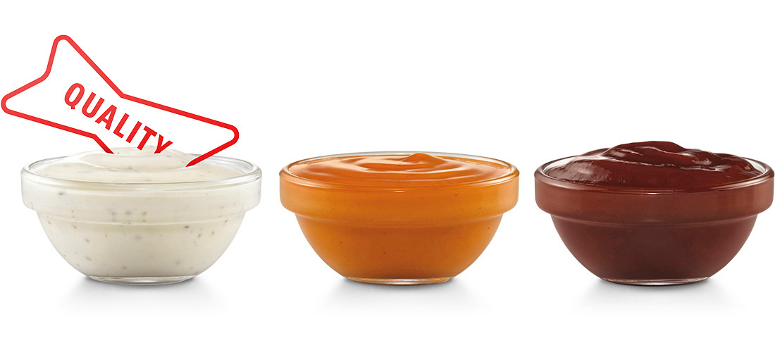 The word "QUALITY" being dipped int one of three small bowls with various dipping sauces