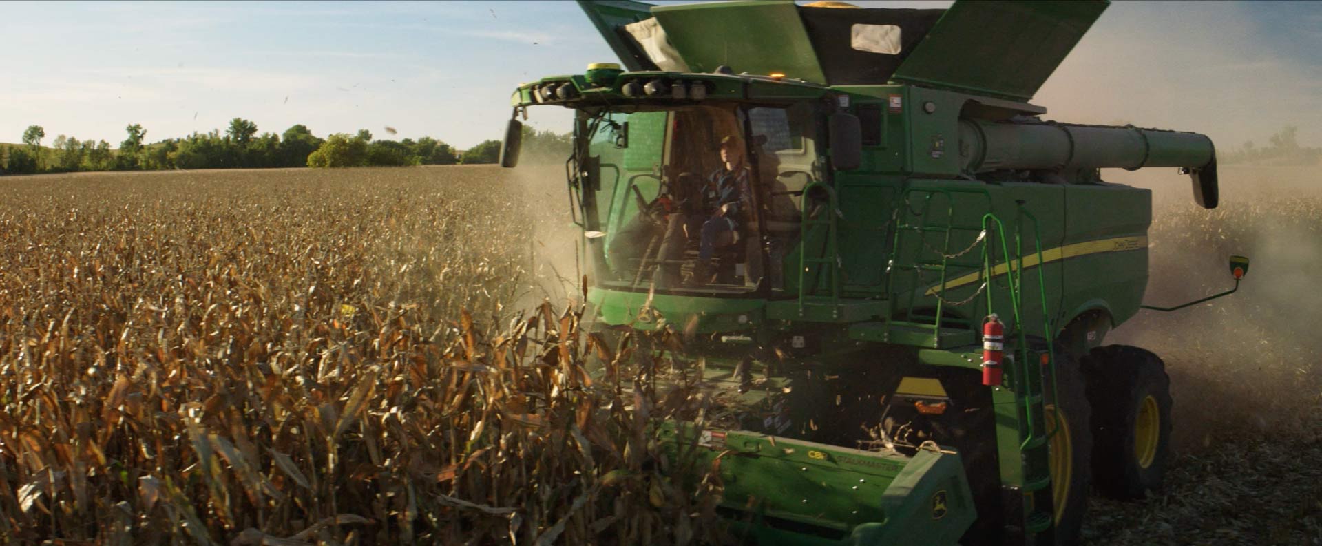 Exterior view of a harvesting combine driven by young woman