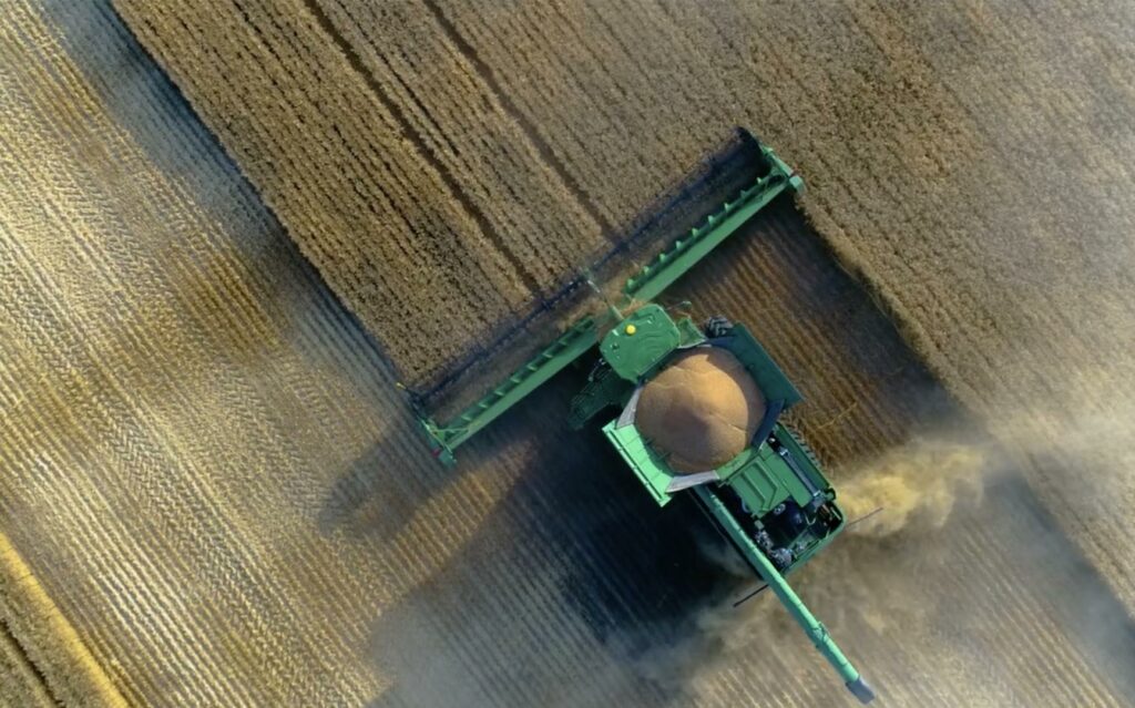 Overhead shot of combine harvesting in field
