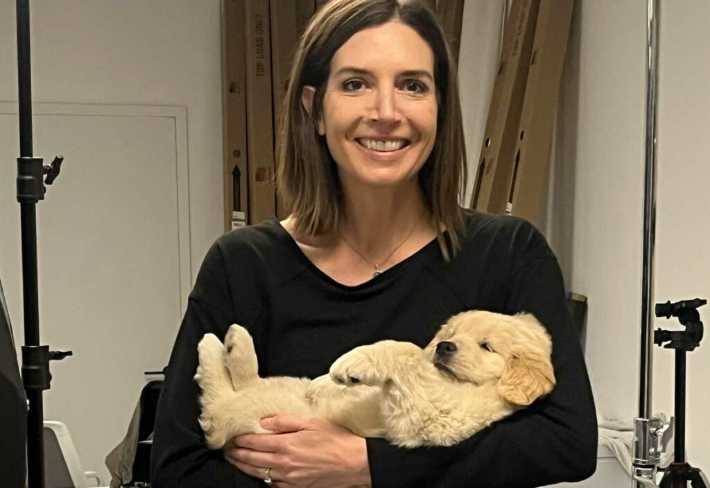 Signal Theory employee holding a sleepy Labrador puppy