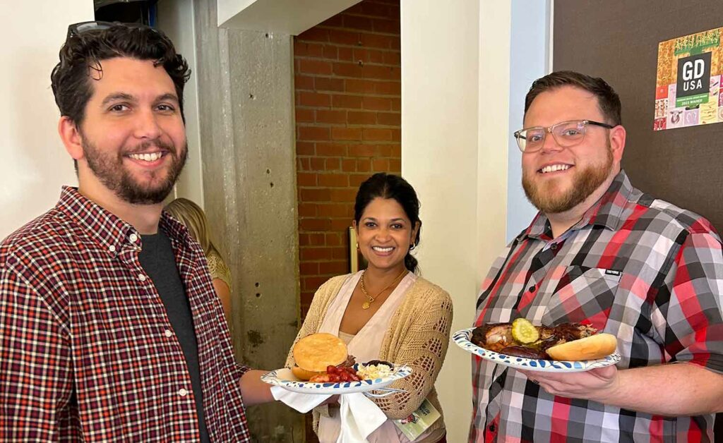 Three Signal Theory employees show off their plates at the United Way chili cook-off